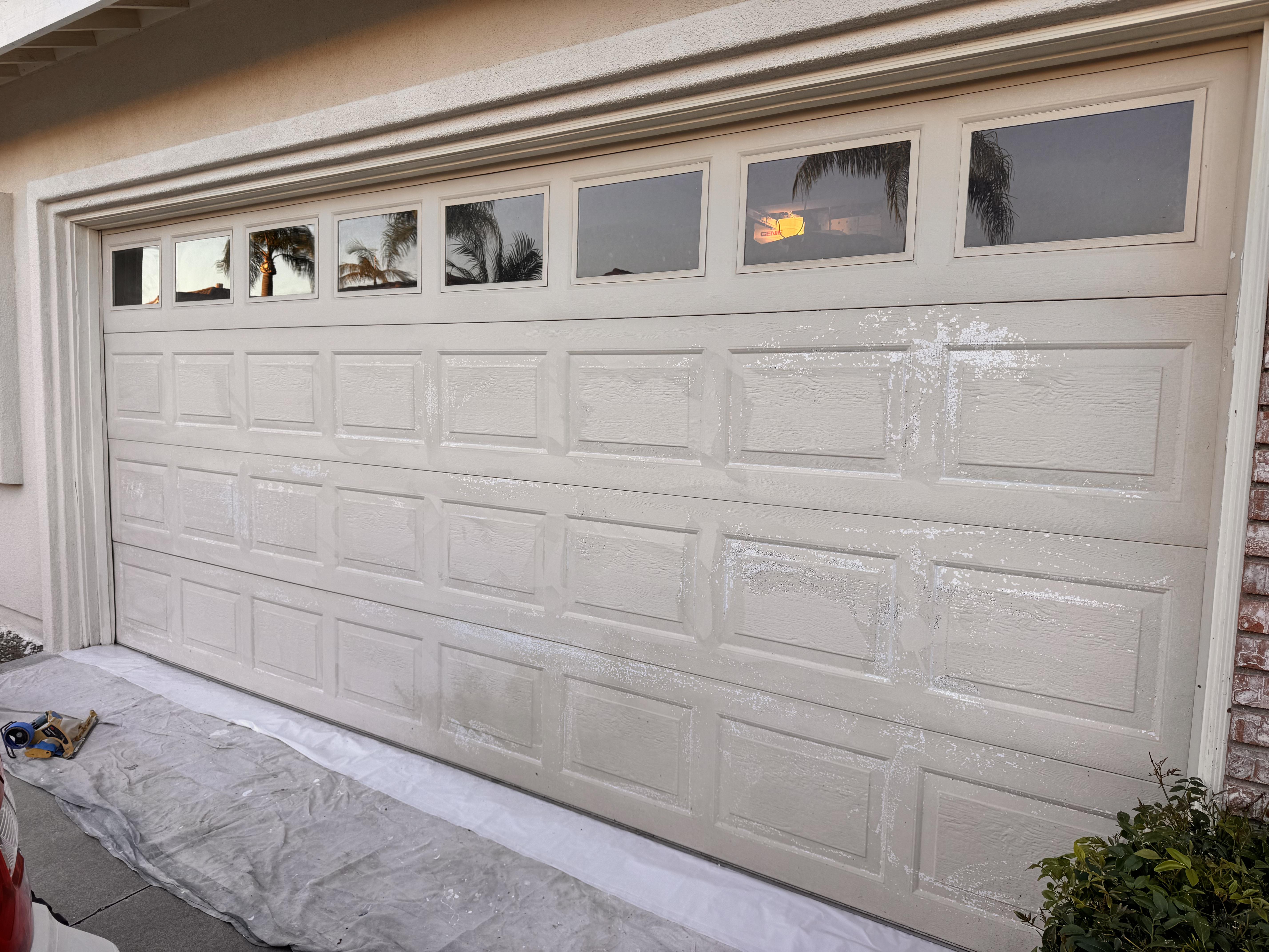 Before photo of faded garage door with peeling and worn finish